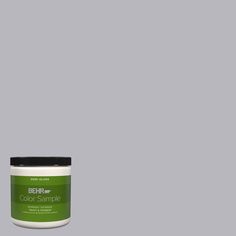 a green paint can with the words behre color sample on it and an image of