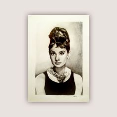 a black and white photo of a woman wearing a necklace with her hair in a bun