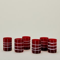 red glass cups lined up against a white background