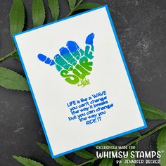 a card with an image of a hand holding the word love on it, and some leaves around it