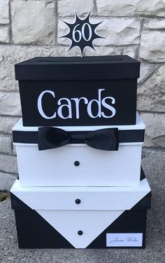 a black and white card box with a bow tie on top