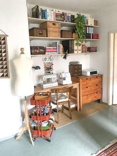 a room with a desk, chair and bookshelf