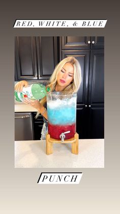 a woman is pouring some liquid into a blender with the words red, white, and blue on it