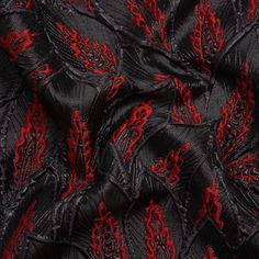 Embers burn among the phoenix wings on this Metallic Black and Red Decorated Feathers Luxury Brocade. A melange of black and red feathers shines against a black background, their raised outlines creating a dimensional face and a tactile texture. Run your hand across the surface to feel the sandpapery metallic threading and the spongy, embossed plumes. Create voluminous gowns and circle skirts with the malleable drape, or fashion structured jackets, bodices, and more. As this fabric is slightly translucent, a silk habotai lining is recommended to increase opacity, comfort, and luxury! Red And Black Gown, Dnd Rogue, Fallen Petals, Phoenix Wings, Glowing Embers, Metal Armor, Board Mood, Mood Designer Fabrics, The Fates