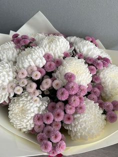 a bouquet of white and pink flowers on a plate