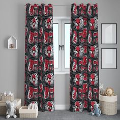 the curtains in this room are decorated with red and black spider - man faces on them