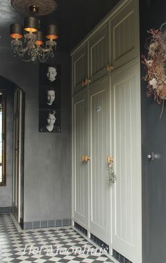 an entry way with two doors and chandelier hanging from it's ceiling