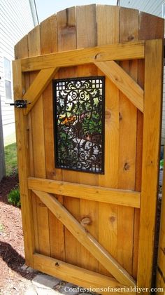 a wooden gate with iron work on it