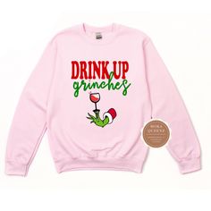 Shop our super cute Drink up Grinches Christmas Shirt today. This Grinch Christmas Shirt is sure to be a hit at your Christmas Party. This Funny Grinch Sweater is unisex and available in sizes S-4X.Get either your normal size (for a loose fit) or size down for a more fitted look.(e.g., if you are a Ladies XL, choose Unisex L)*** UNISEX FIT offers a relaxed fit that works well for men and women. Sweatshirt -50% ring-spun cotton/50% polyester; -Soft fleece inside -Mid-weight, Boyfriend/unisex fit Holiday Pink Long Sleeve Tops, Pink Long Sleeve Holiday Top, Funny Long Sleeve Christmas Tops, Fun Winter T-shirt With Crew Neck, Funny Print Sweatshirt For Winter, Funny Print Winter Sweatshirt, Cute Long Sleeve Holiday T-shirt, Cute Winter Letter Print T-shirt, Pink Long Sleeve T-shirt With Funny Print