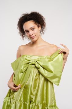 Make a grand entrance with our East Village Bow Taffeta Dress by Madeline Marie. This strapless piece features a dramatic oversized bow and a voluminous skirt, crafted from luxurious satin fabric. Ideal for formal events and glamorous evenings. Glamorous Taffeta Gown For Party, Chic Strapless Dress With Detachable Bow For Evening, Chic Satin Strapless Dress With Bow, Chic Strapless Satin Dress With Bow, Elegant Voluminous Party Gown, Spring Evening Strapless Dress With Bow, Glamorous Strapless Dress With Bow For Evening, Sleeveless Satin Strapless Dress With Bow, Glamorous Gala Dress With Satin Bow