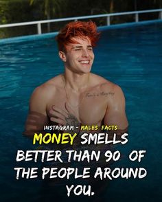 a man with red hair is smiling in the water and has his hand on his chest