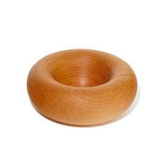 a wooden bowl sitting on top of a white surface