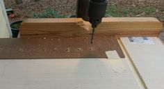 a drill is being used to make holes in the wood for an unfinished piece of furniture