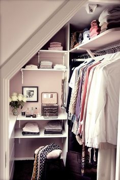 the closet is organized with clothes and other items