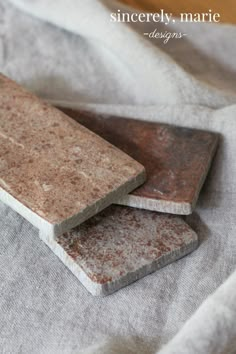 two pieces of stone sitting on top of a cloth