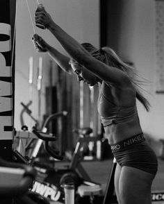 a black and white photo of a woman working out