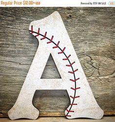 a wooden letter with baseball stitching on it