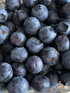 blueberries are in a glass bowl on the table