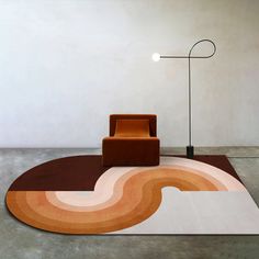 a chair sitting on top of a rug next to a lamp