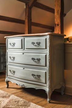 a white dresser with drawers in a room