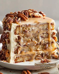 a piece of cake on a plate with pecans and caramel drizzle