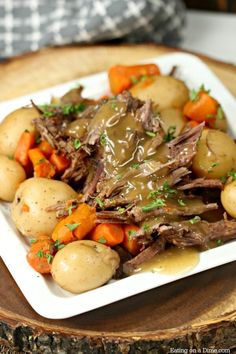 the best crock pot roast with potatoes and carrots is served on a white plate