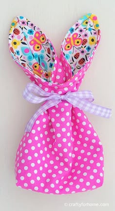 a pink polka dot bag with white polka dots on it and a bow at the top