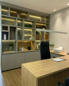 an office with wooden floors and built - in shelving units on either side of the desk