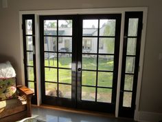 a living room with sliding glass doors leading to a yard