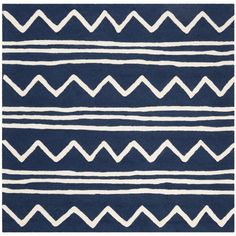 a blue and white area rug with wavy lines on the bottom, and horizontal stripes on the top