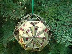 an ornament hanging from a christmas tree decorated with red and yellow hearts on it