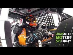 a man sitting in the cockpit of a racing car