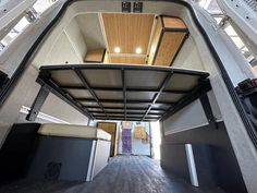 an inside view of a vehicle with its doors open and the floor is made out of wood