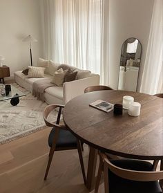 a living room filled with furniture and a large mirror on top of a table in front of a couch