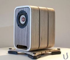 a wooden speaker sitting on top of a table