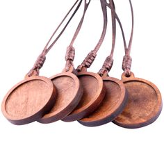 four wooden discs are hanging from a cord