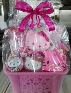 a pink basket with hello kitty items in it