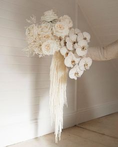 a bouquet of white flowers hanging from the ceiling