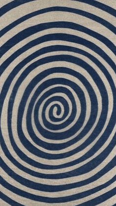 a blue and white rug with an abstract design in the center on top of it