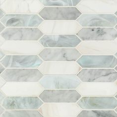 a white and grey marble mosaic tile with hexagonal design in the center, on top of each other