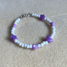 - One Of A Kind Beaded Charm Bracelet - Featuring Purple And White Seed Beads And Shaped Beads - Silver Colored Hardware - Clasps Closed. No Stretch. - Size/ Circumference Is 6.5” - Handmade (By Myself). Perfect To Treat Yourself Or To Give As A Unique Gift! **Add 2 Jewelry Items Marked “2 For $20” To Your Bundle And I Will Send You An Offer For $20** Check Out The “Boutique” Tab In My Closet For Handmade Earrings, Bracelets, And Necklaces! Tiny Bead Bracelet, Purple Beaded Bracelets, Jewelry Stacking, Boys Bracelets, Beaded Charm Bracelet, Hearts And Stars, Crystal Bead Jewelry, Wrist Stacks, Beads Bracelet Design