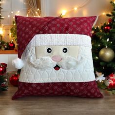 a santa claus pillow sitting on top of a wooden table