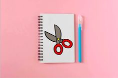 a notebook with a pair of scissors on it