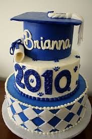 a three tiered graduation cake decorated with blue and white icing