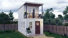 a small white house sitting on top of a lush green field next to a wooden fence