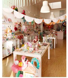 a room filled with lots of toys and decor on the walls, including lamps hanging from the ceiling