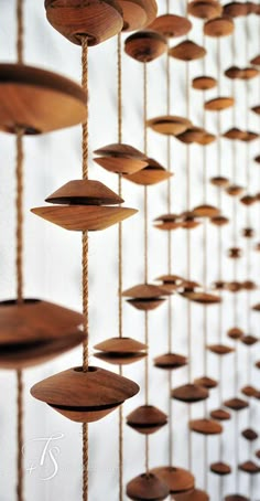 wooden wind chimes hanging from strings in a room