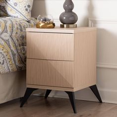 a night stand with two drawers and a lamp on top