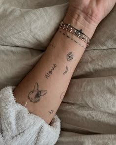 a person's arm with tattoos on it and the words mom written in cursive writing