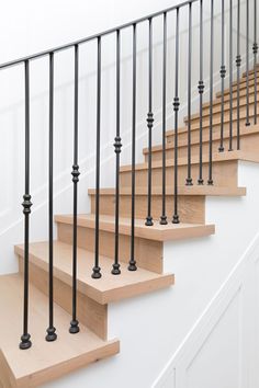 a set of wooden stairs with black railings